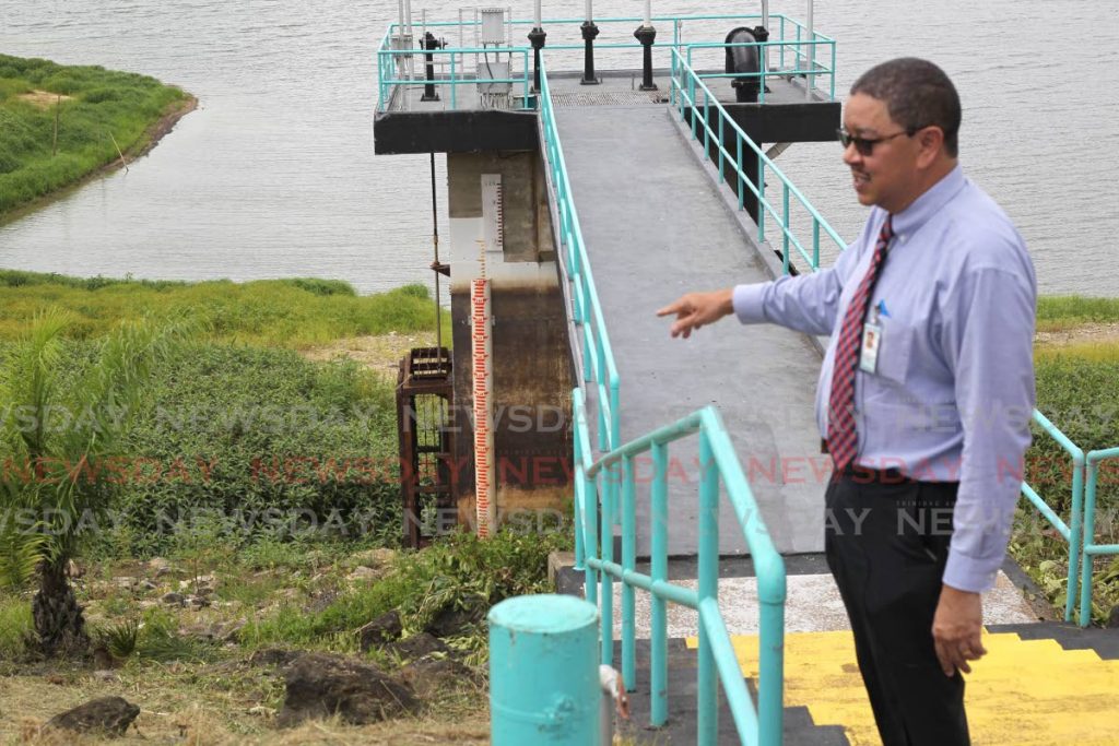 Shrub and grass now cover the bed of what should be higher water levels at WASA's Arena Reservoir shown to the media by CEO Alan Poon King on Thursday. The levels remain extremely low amid a below average rainy season. PHOTO BY ROGER JACOB  - 
