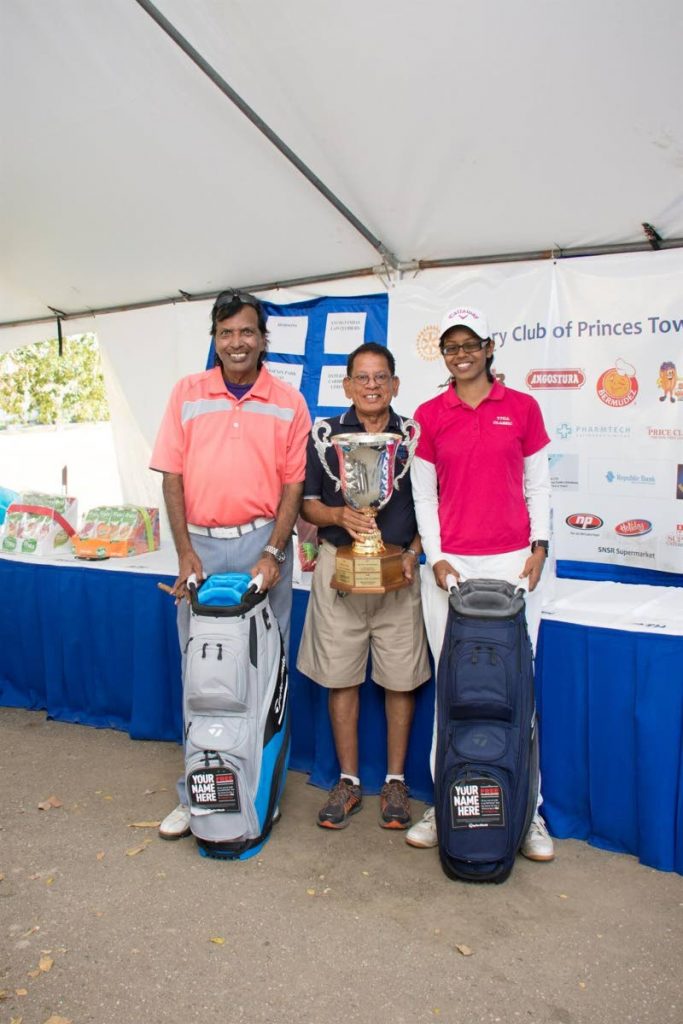 Haroon Joseph (left) and Sarah Ramphal (right) pose with the Raubin Harnarine Challenge trophy (held by then-president of the Princes Town Rotary Club Jamir Ousman) on March 8 at the Rotary Club of Princes Town Annual Fund Raising Golf Tournament.  - 