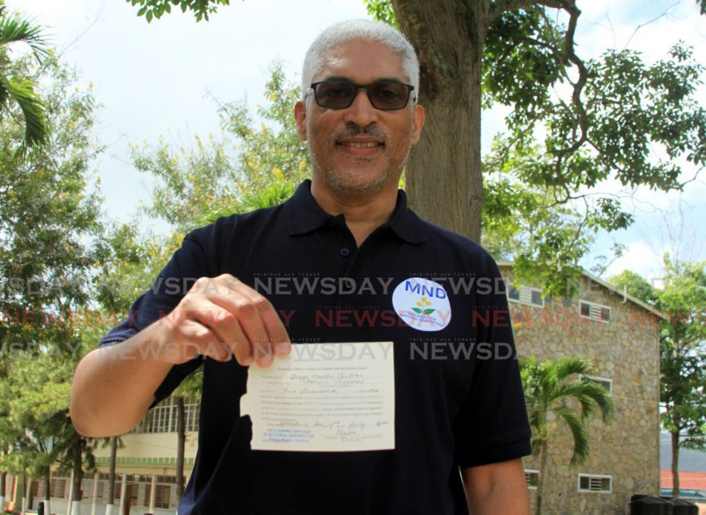 Leader of the Movement for National Development Garvin Nicholas shows his nomination slip after filing at the Diego Martin Central Secondary School. - Ayanna Kinsale