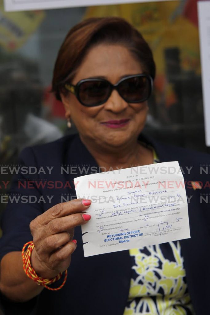 Political leader of the UNC Kamla Persad Bissessar showing her receipt after  filing her nomination papers at the Elections and Boundaries office in Penal for the upcomming General Elections on August 10. - Lincoln Holder
