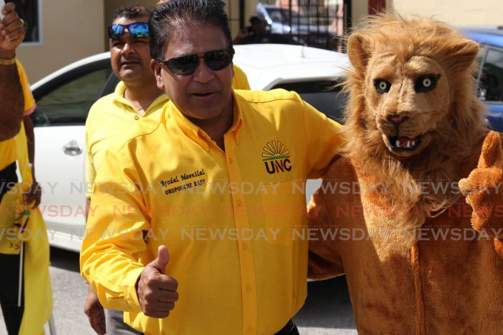 UNC Oropouche East candidate Dr Roodal Moonilal and a lion mascot greet supporters on Mohess Road, Penal on nomination day on July 17.  Photo by Lincoln Holder