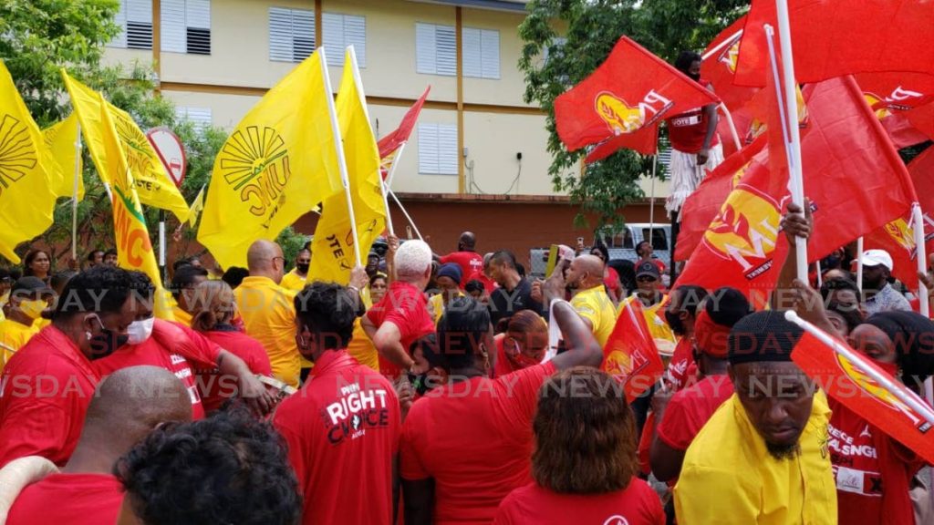 In this file photo, supporters of the two main political parties, the People's National Movement and the United National Congress, mingle as their respective candidates for the upcoming general election file their nomination papers in the St Joseph constituency on July 17. - 