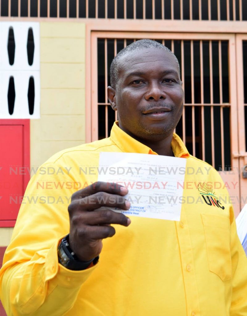 UNC candidate Rodney Stowe shows his slip after filing nominaton papers for the electorial district of Laventille West at Malick Youth Facility, 7th Avenue, Barataria on Friday morning. - Vidya Thurab