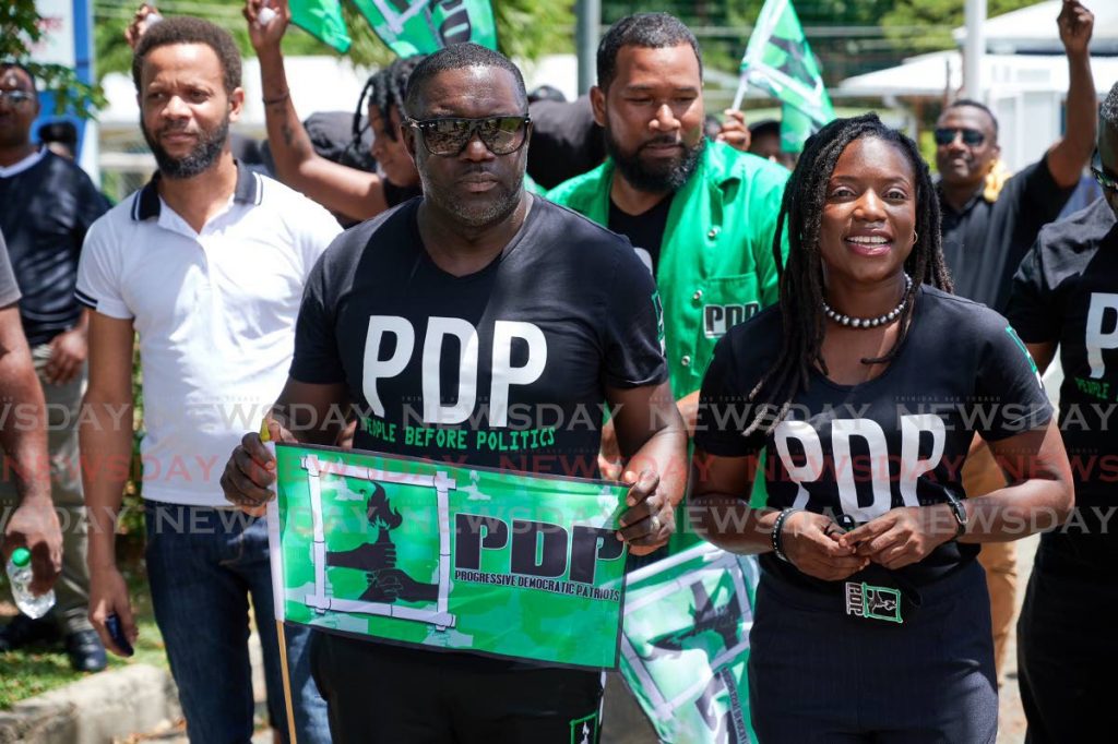 PDP leader and Tobago East candidate Watson Duke escorts the party's Tobago West candidate Tashia Grace Burris to file her nomination papers at Calder Hall Multipurpose Facility, Calder Hall on Friday. PHOTO BY LEEANDRO NORAY - 