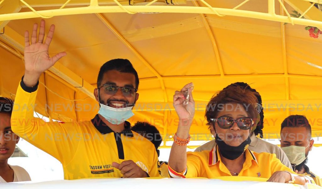 UNC political leader Kama Persad-Bissessar with the party’s Barataria/San Juan candidate Saddam Hosein during a motorcade over the weekend. PHOTO BY ROGER JACOB - ROGER JACOB