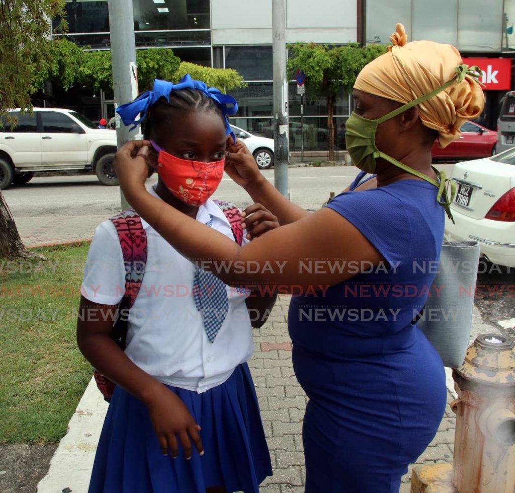 Kelly Callender made sure the mask on her daughter Saphyre fits properly, as the stardard five student of Nelson Street Girls' RC  goes back to school on Monday. - SUREASH CHOLAI