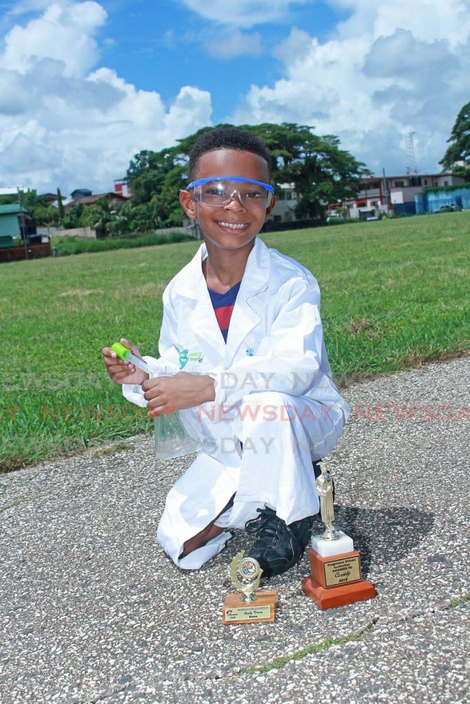 Kassidy Primus is all smiles in his lab coat, and with his Erlenmeyer flask and two science awards from Progressive Private Institution at Skinner Park, San Fernando. He also wore his football uniform under his coat to go play a game.  - 