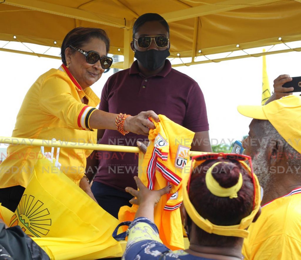 UNC leader Kamla Persad-Bisessar greets supporters during a motorcase in the St Joseph constituency on July 21. On Saturday, the party said it has suspended campaigning because of Tropical Storm Gonzalo. - ROGER JACOB