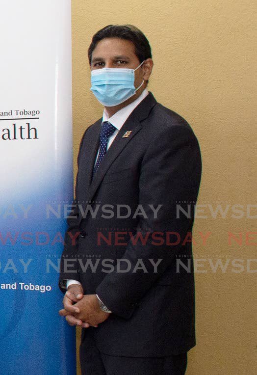 Chief Medical Officer Dr Roshan Parasram wears a mask during a recent handing over ceremony at the Ministry of Health. - 