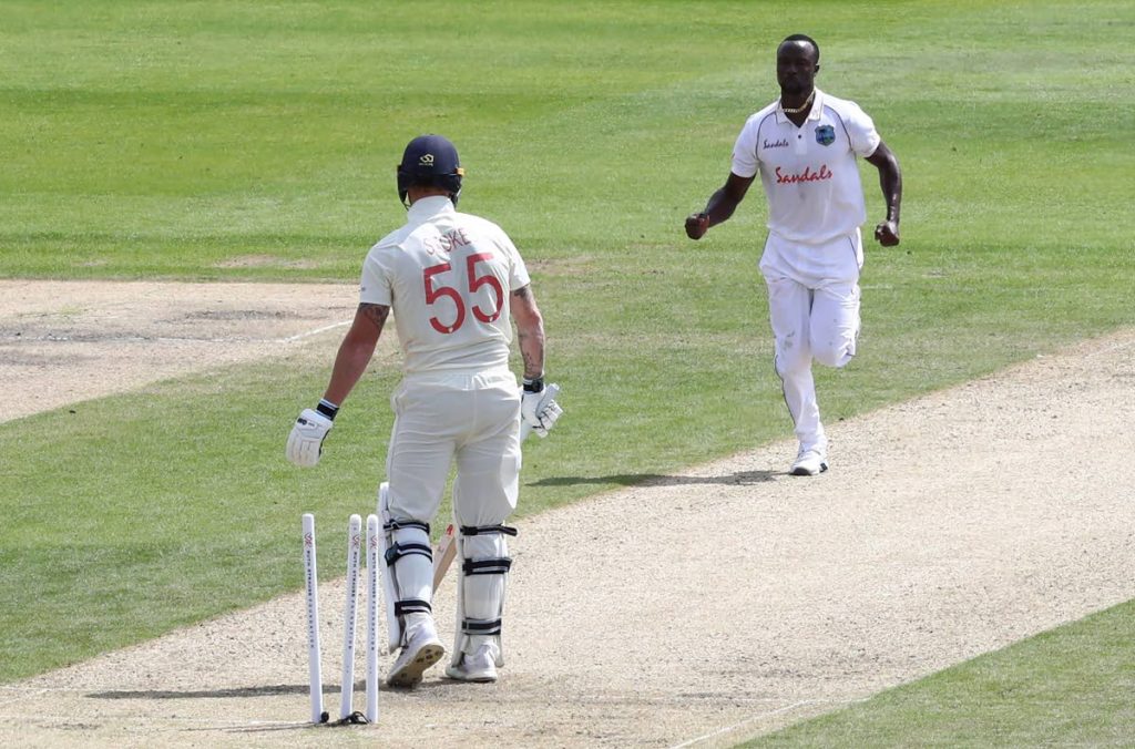 West Indies' Kemar Roach (right), celebrates the dismissal of England's Ben Stokes (left), during the first day of the third Test match between England and West Indies at Old Trafford in Manchester, England, on Friday. (AP PHOTO) - 