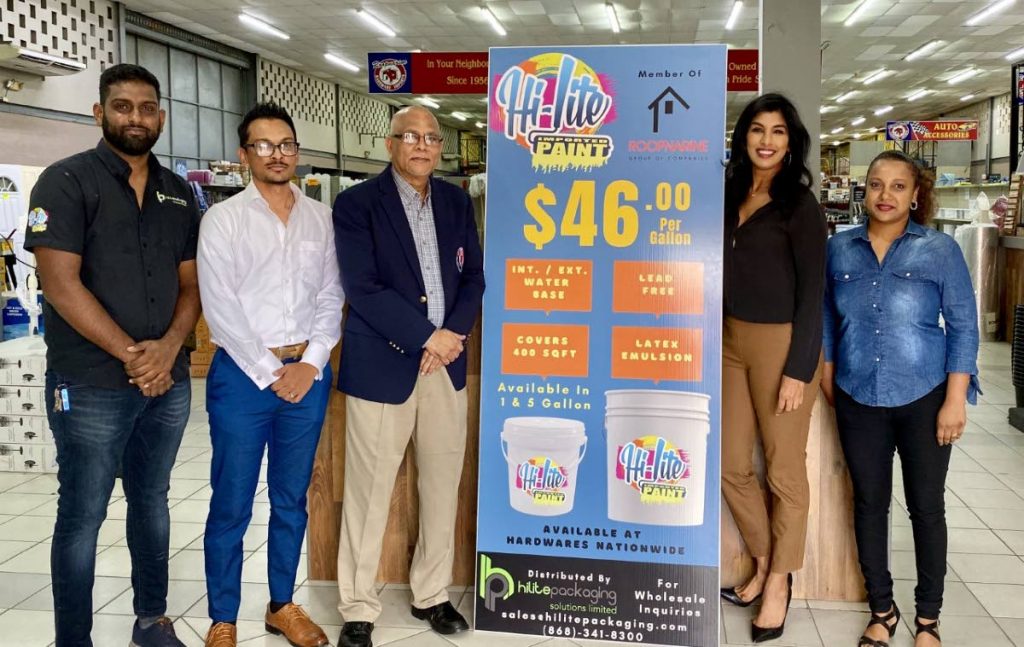 Ish Roopnarine, left, of Roopnarines Hardware, and staff members with TTCB president Azim Bassarath, third from left, at the presentation of the Hi-lite paint for the National Cricket Centre. - 