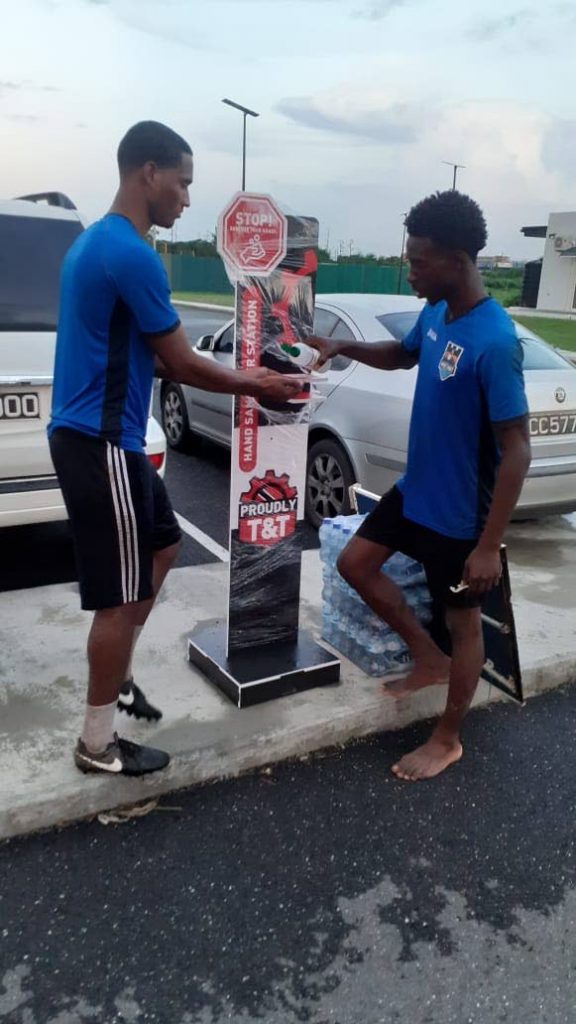 Players from Real West Fort United sanitise courtesy the TT Manufacturers Association. - 