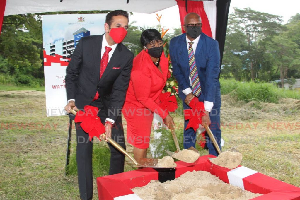 AG and PNM San Fernando West candidate Faris Al-Rawi, SWRHA board member Jennifer Marryshow and San Fernando Mayor Junia Regrello turn the sod for the start of construction of the car park on Monday.  PHOTO BY LINCOLN HOLDER - 