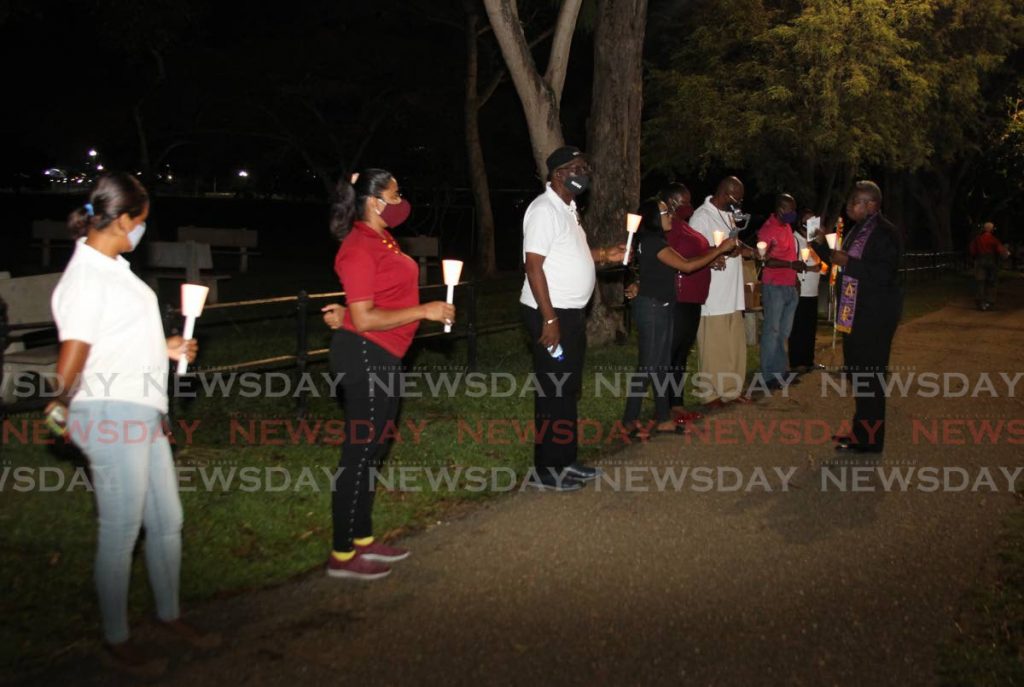 NATUC members take part in a candlelight vigil outside the Office of the Prime Minister at Whitehall, Queen's Park Savannah, Port of Spain, on Thursday. - ROGER JACOB