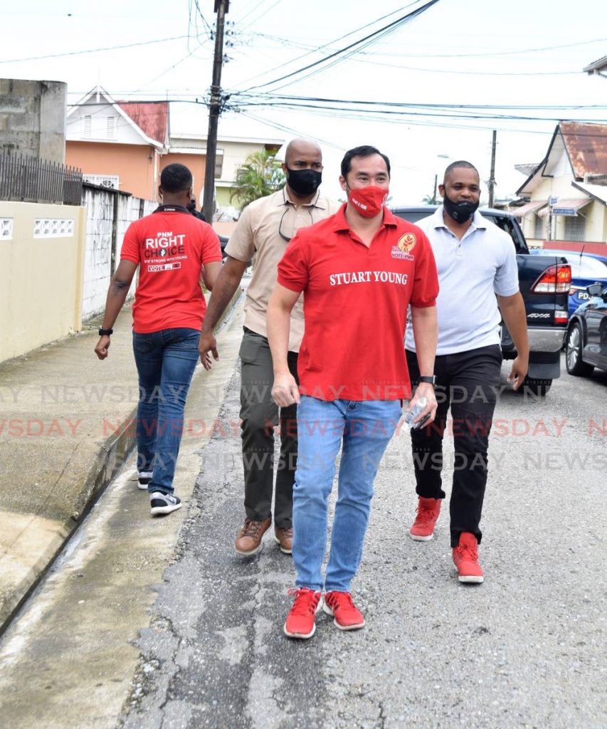 National Security Minister and PNM Port of Spain North/St Ann's West Stuart Young walks on Pelham Street, Belmont during a motorcade on Saturday. PHOTO BY VIDYA THURAB - 