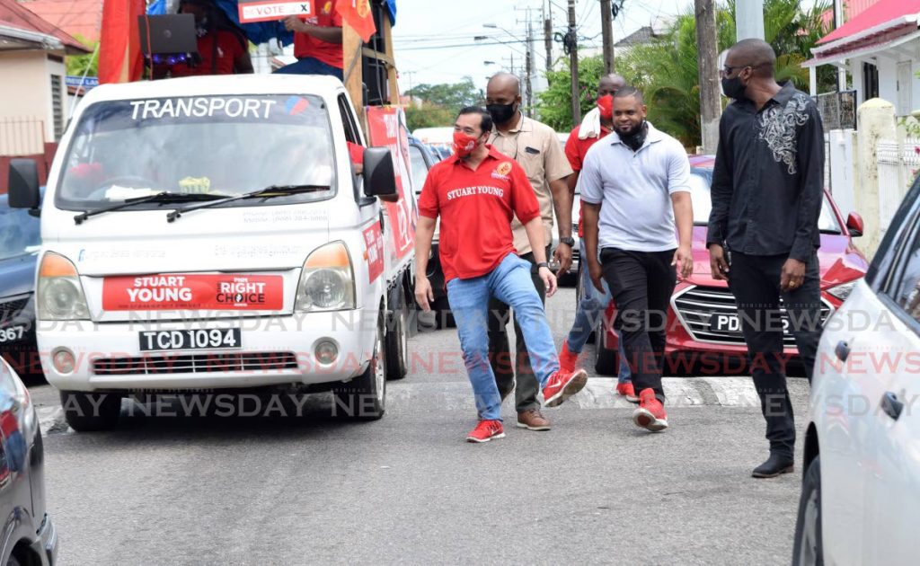 PNM candidate for Port-of-Spain North/St. Ann's West, Stuart Young does a dance move  as he walked about in Belmont, Port of Spain on Saturday afternoon during his motorcade/rally. - Vidya Thurab