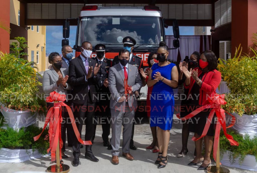 National Security Minister Stuart Young, centre, cuts the ribbon to open the Roxborough Fire Station on Tuesday. Also present at the ceremony were Chief Secretary Ancil Dennis, PNM Tobago East candidate Ayanna Webster-Roy and other officials. PHOTO BY DAVID REID - 