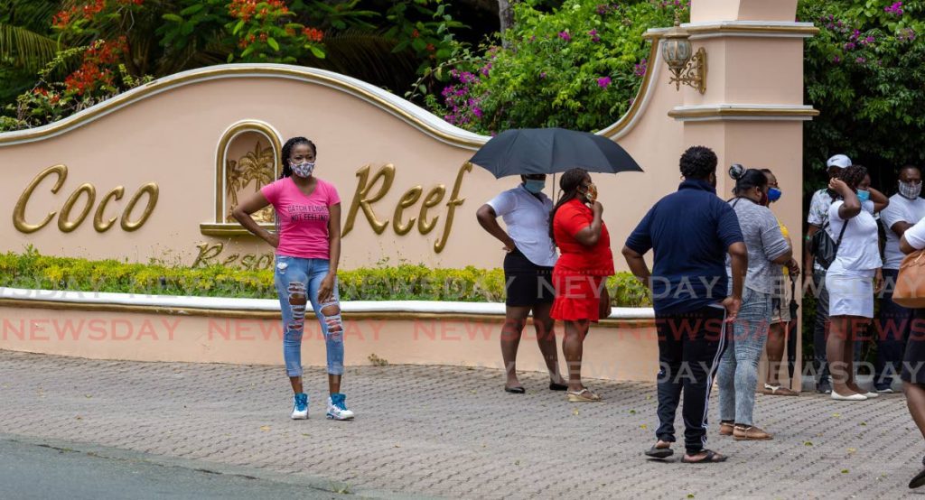 Coco Reef Resort & Spa employees gather at the entrance to the hotel on Wednesday to protest a decision by management to send them home without pay for two more months. PHOTO BY DAVID REID  - 