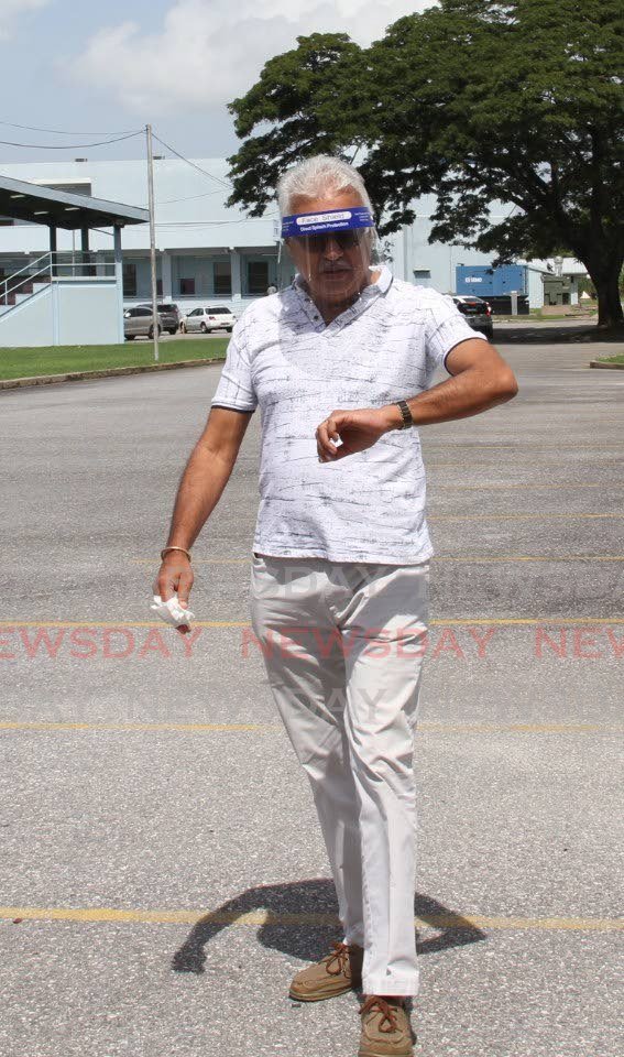 PNM candidate for St Joseph and Minister of Health Terrence Deyalsingh wears a face shield while walking towards reporters outside the Cipriani Labour College where he cast his vote on Monday. - Shane Superville