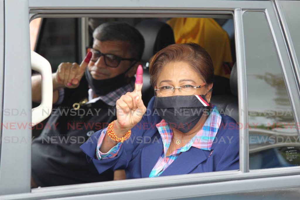 UNC political leader Kamla Persad Bissessar and Dr Gregory Bissessar wave to supporters after leaving the Hermitage Presbyterian school where they voted in the 2020 General Elections - Lincoln Holder