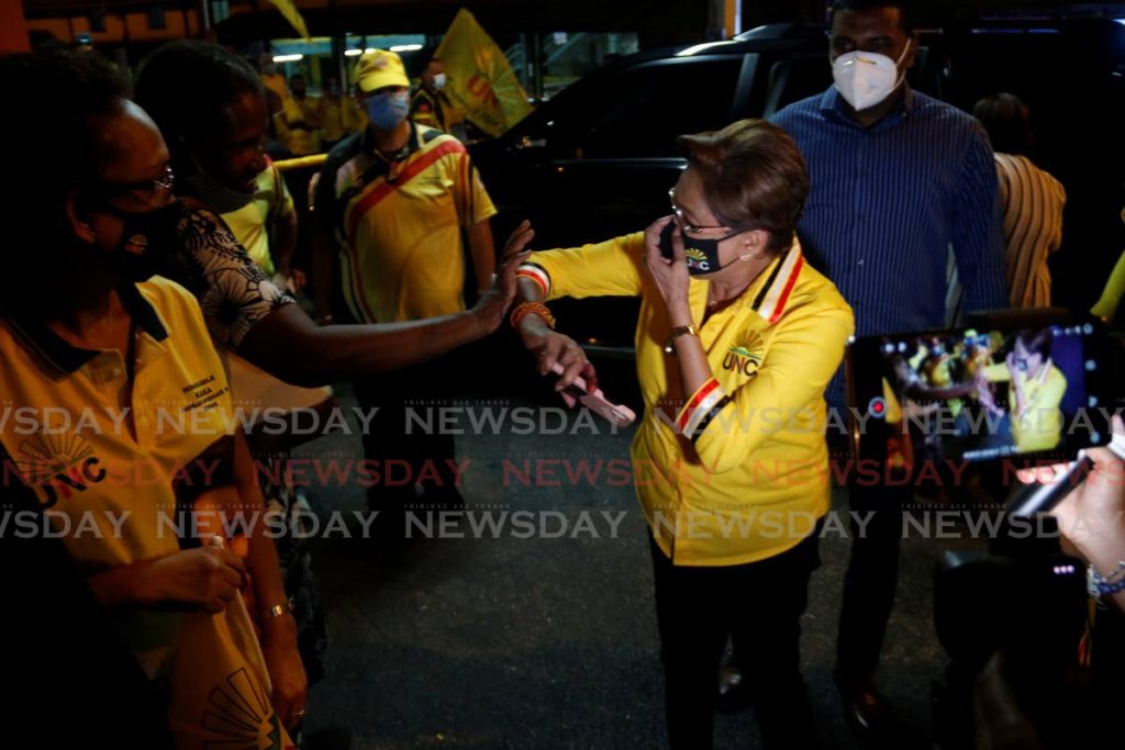 UNC Political Leader Kamla Persad-Bissessar greets supporters as she arrives at her constituency office in Siparia on Monday night. - Marvin Hamilton
