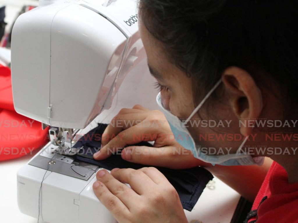 A female prison inmate sews a face mask at Golden Grove Prison, Arouca. Photo by Angelo M. Marcelle
