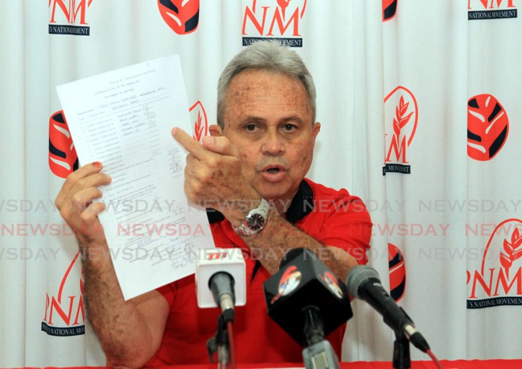 Minister of Finance Colm Imbert shows a statement of the poll (form 69) document to the media during a press conference held at the Balisier House, Tranquility Street, Port of Spain, Thursday. - Ayanna Kinsale