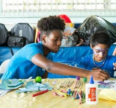 Youth activist Ianthe does a craft activity with a special child. - Sataish Rampersad