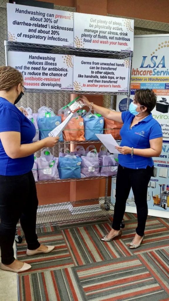 Managing director Leela Ramsingh, right and contract admin- Sales, Kathleen Lawson with the “happy bags” to be donated. - 