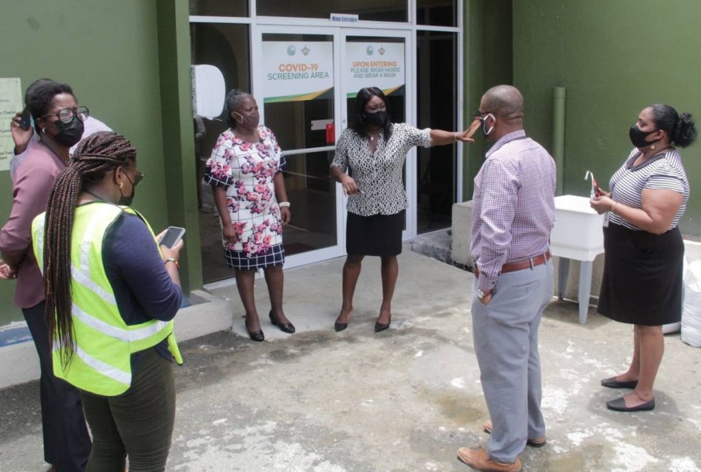 Health Secretary Tracy Davidson-Celestine, centre, chats ahead of a tour of a covid19 isolation facility, Fort King George, Monday. PHOTO COURTESY THA - 