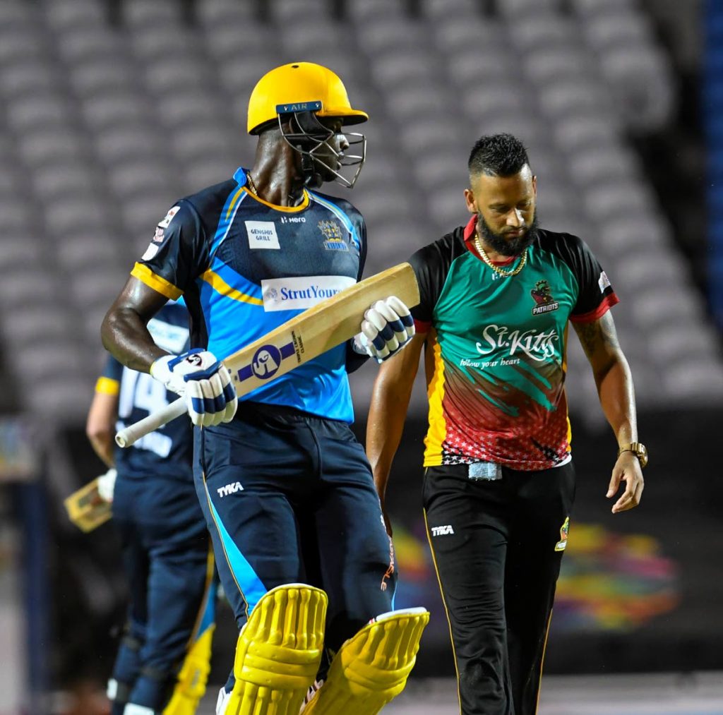  Jason Holder (L) of Barbados Tridents gets runs off Rayad Emrit (R) of St Kitts and Nevis Patriots during the Hero Caribbean Premier League Match 2 between Barbados Tridents and St Kitts & Nevis Patriots at Brian Lara Cricket Academy on Tuesday, in Tarouba. - CPL T20 via Getty Images