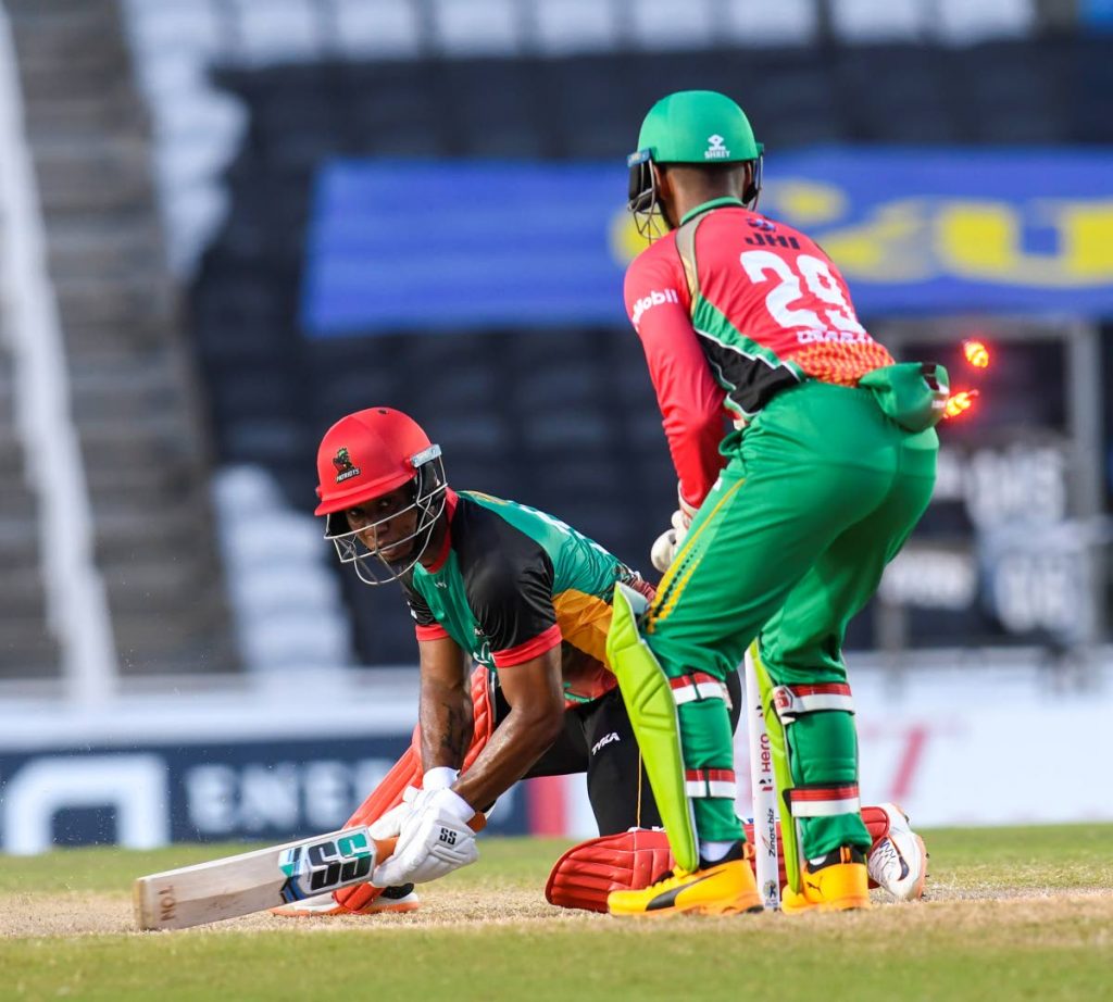 Evin Lewis (L) of St Kitts & Nevis Patriots is dismissed by Nicholas Pooran (R) of Guyana Amazon Warriors during the Hero Caribbean Premier League match 4 between Guyana Amazon Warriors and St Kitts & Nevis Patriots at Brian Lara Cricket Academy last week in Tarouba. - CPL T20 via Getty Images