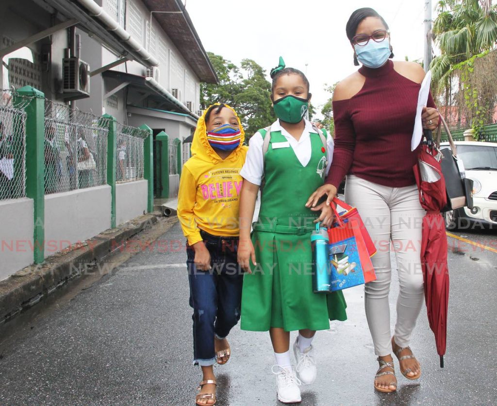 A St Gabriel's Girls' RC student with her family after doing the SEA exam at her Lord Street, San Fernando school 

- Lincoln Holder  