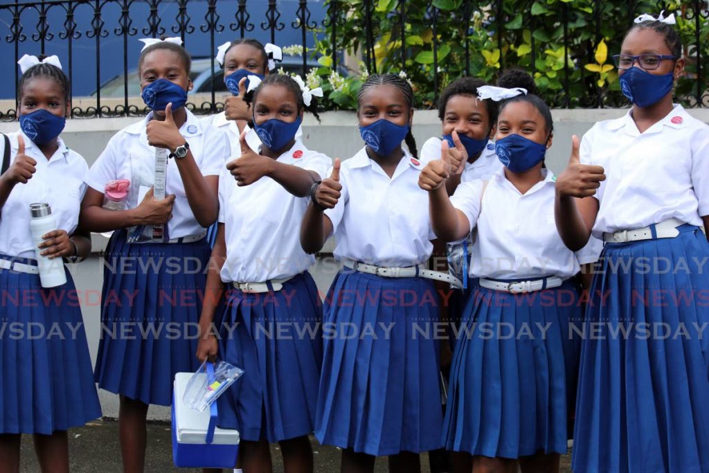File photo: SEA students of Sacred Heart Girls RC School, Port of Spain, give the thumbs up after finishing the exam in August. - SUREASH CHOLAI