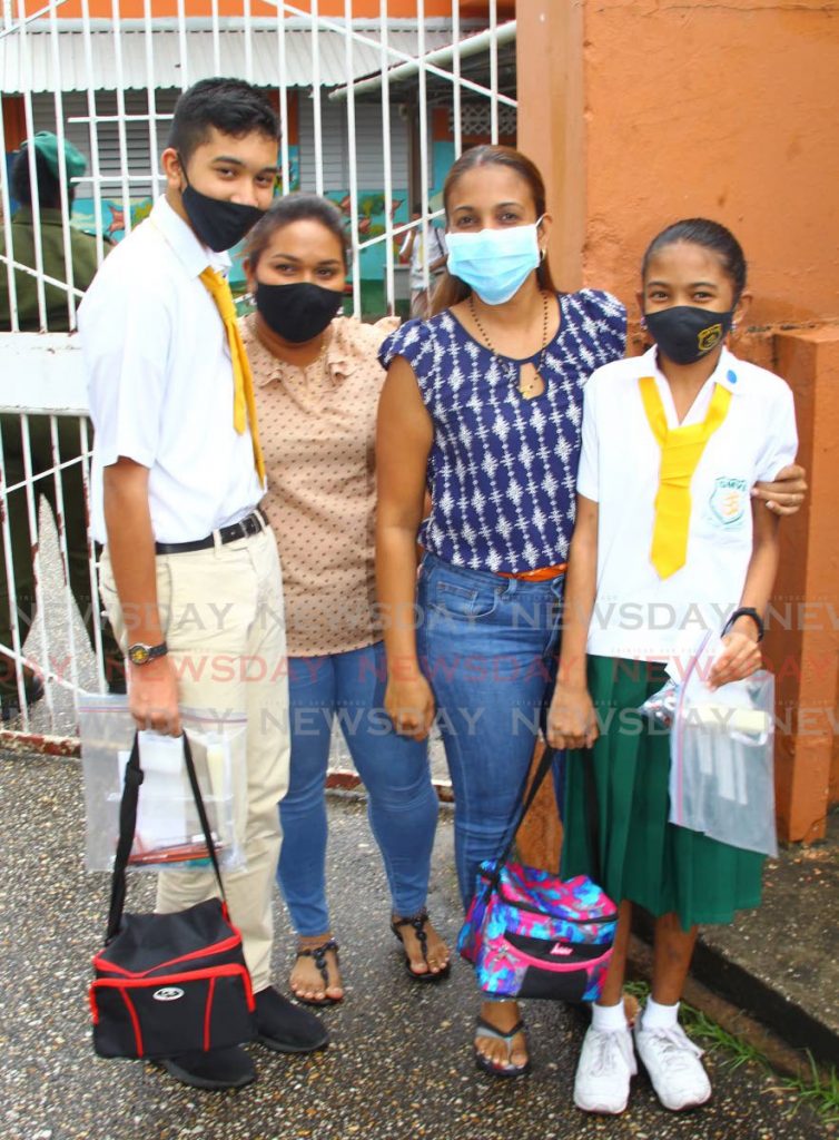 Cousins Mahesh Goberdhan and Tia Goberdhan with their mothers Reshme and Neesha after writing the SEA exam at the Gandhi Memorial Vedic School on Thursday. - ROGER JACOB