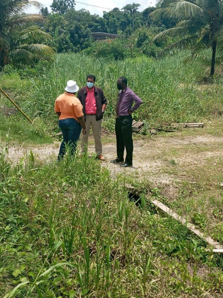 Mayaro MP Rushton Paray, centre, speaks with MRCRC's chairman Raymond Cozier, left, and drainage supervisor, Laverne Edwards during a tour in the district on Monday.  - Courtesy Raymond Cozier 
