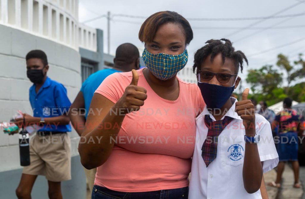 In this August 20 file photo, Tehilla Chapman, right, hugs her mother Semoy Bedlow Chapman after writing the SEA at Scarborough Methodist Primary School in Tobago. - DAVID REID