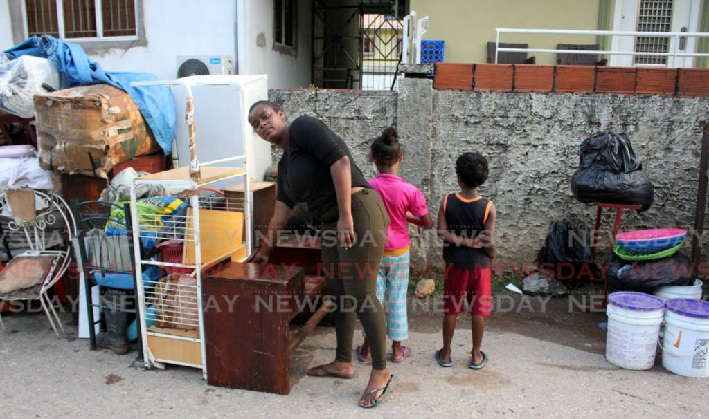 Lauren Maloney and her daughter, seven, and son, six, on Laventille Road, San Juan, after they were evicted from their home by a relative on Monday. - Angelo Marcelle