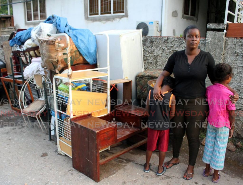 THROWN OUT: Lauren Maloney and her daughter, 7, and son, 6, stand on Lanventille Road, San Juan, after they were evicted from their home by a relative on Monday. - Angelo Marcelle