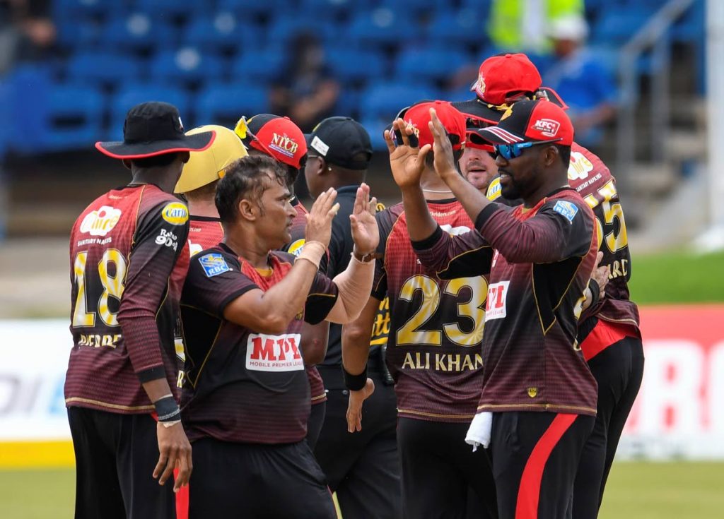 Pravin Tambe (L) and Darren Bravo (R) of Trinbago Knight Riders celebrate the dismissal of Najibullah Zadran of St Lucia Zouks during the Hero Caribbean Premier League match 13 between St Lucia Zouks and Trinbago Knight Riders at Queen's Park Oval on Tuesday. - CPL T20 via Getty Images