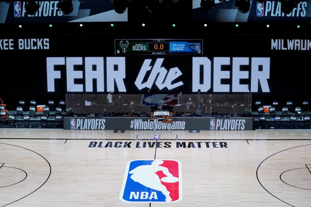 The court and benches are empty of players and coaches at the scheduled start of an NBA first round playoff game between the Milwaukee Bucks and the Orlando Magic, on Wednesday, in Lake Buena Vista, Fla. (AP Photo) - 