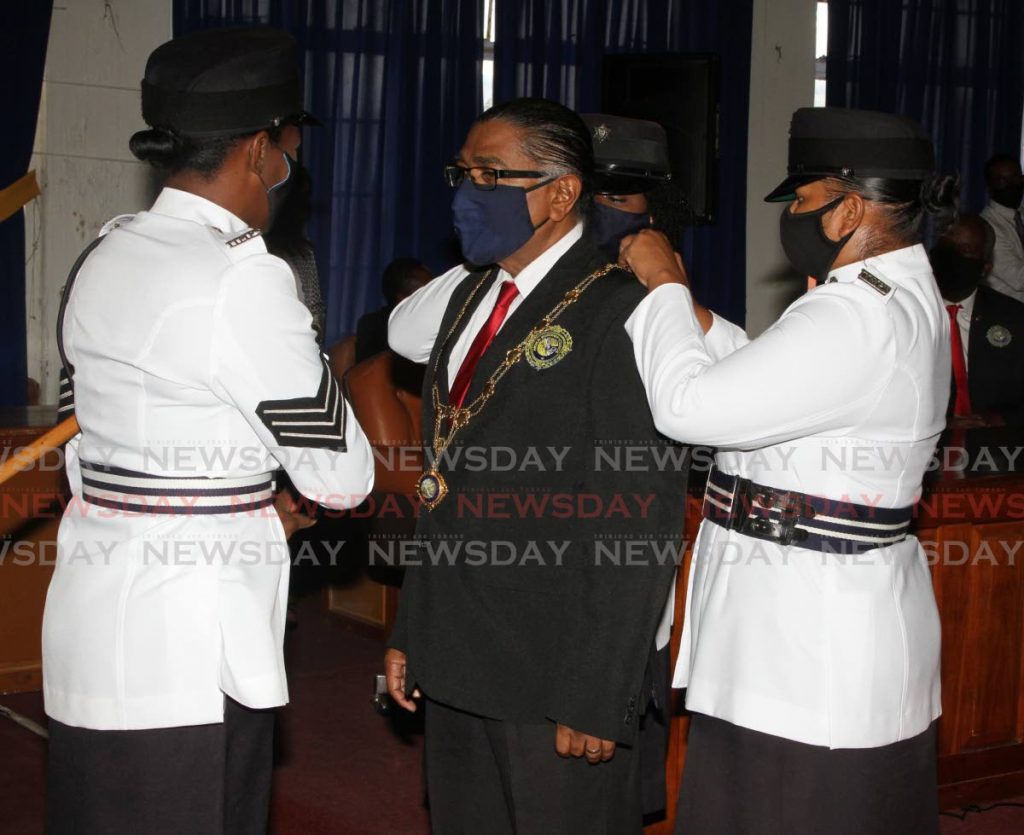 New Arima Mayor Cagney Casimire receives his chain of office from Arima municipal police  on Thursday morning. - Angelo Marcelle