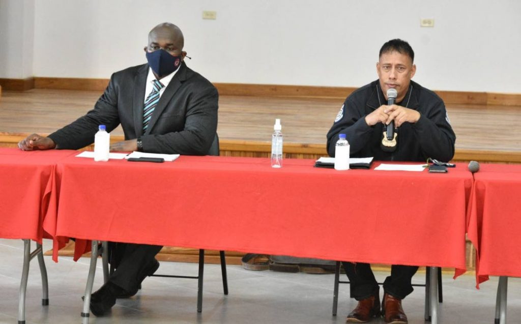 Police Commissioner Gary Griffith and San Fernando East MP Brian Manning discuss security issues with residents of Tarodale at the community centre in San Fernando on Thursday. PHOTO: TTPS - 