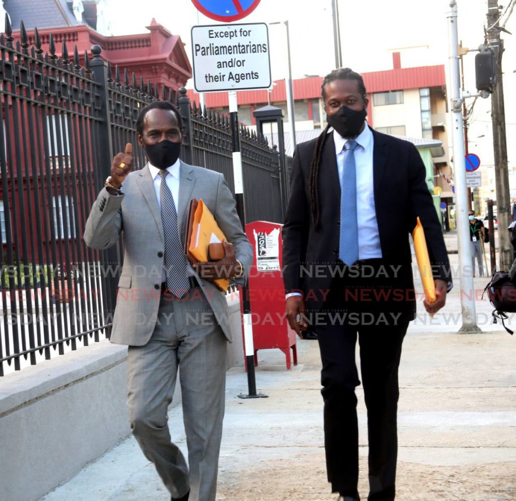 Minister of Youth Development and National Services Fitzgerald Hinds, left, and Laventille East/Morvant MP Adrian Leonce arrive at the Red House for the opening session of the 12th Parliament on Friday. - SUREASH CHOLAI