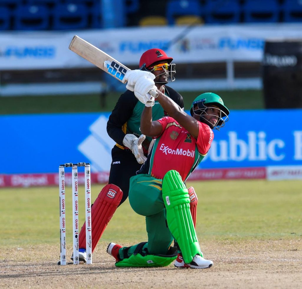 Guyana Amazon Warriors's Nicholas Pooran launches a six against St Kitts and Nevis Patriots on Sunday in the Hero CPL at the Queen's Park Oval, St Clair. PHOTO BY CPL T20 - 