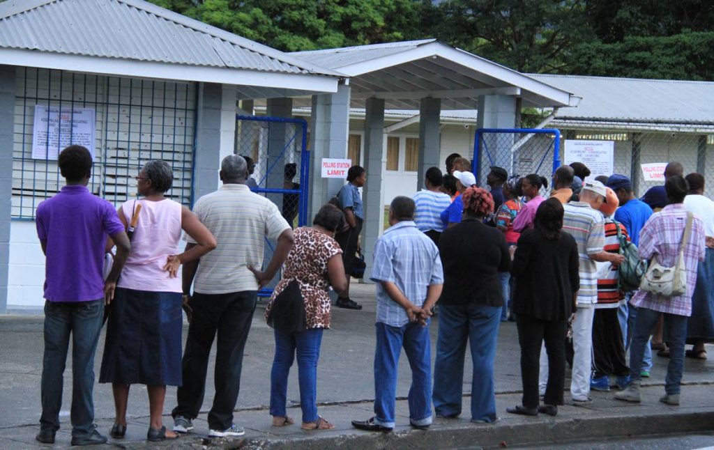 In this September 7, 2015 file photo, people wait to vote at Valencia South Primary School, Valencia in the 2015 general election. Chief Election Officer Fern Narcis-Scope assures all is in place for vote under covid19 measures in the August 10, 2020 general election. - ROGER JACOB