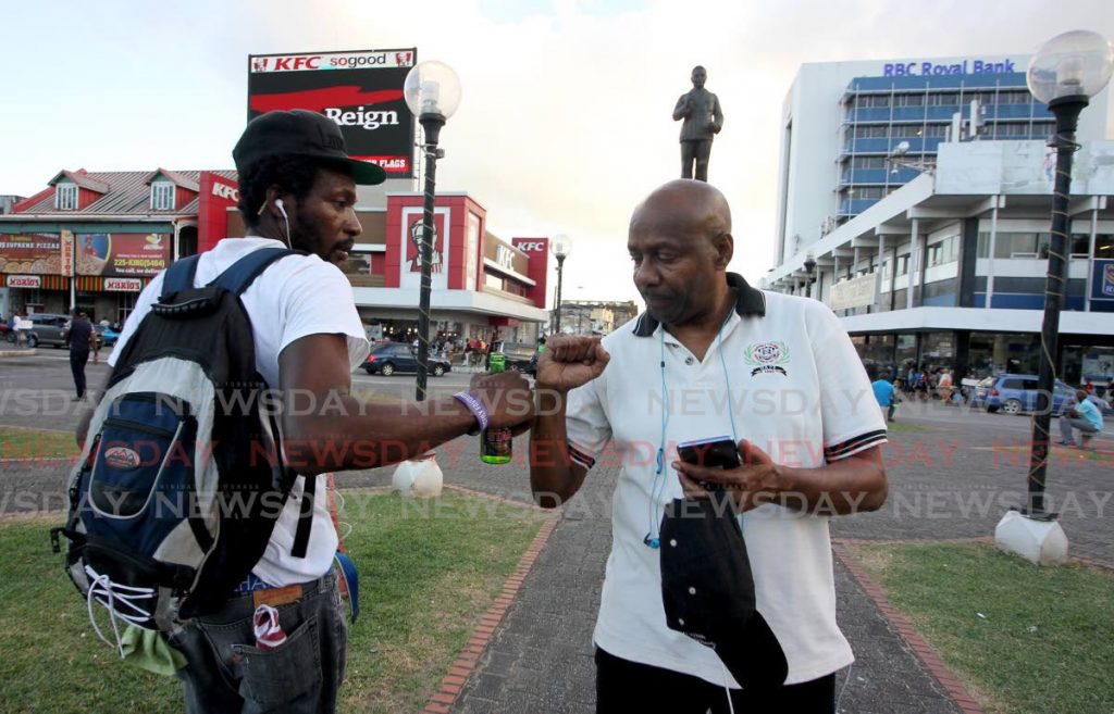 Errol Fabien greets a man during a 24-hour protest walk he embarked on in December 2018. - 