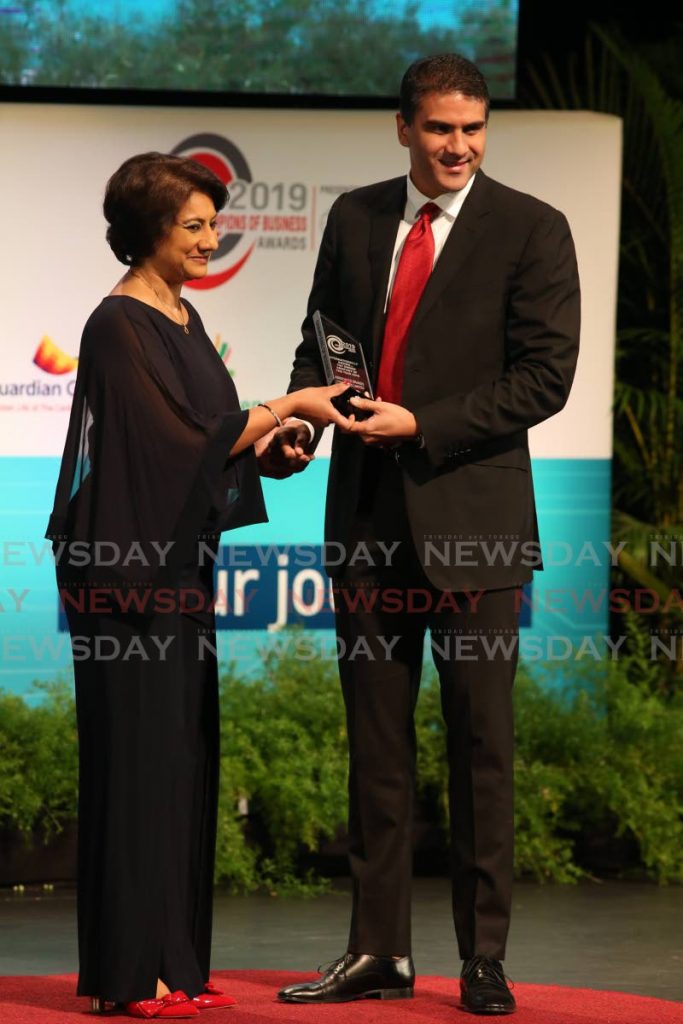 In this November 15, 2019 file photo, Nicholas Lok Jack, group CEO/deputy chairman, Associated Brands Industries, receives the Internationally Known T&T Owned Company of the Year award from First Citizens Group CEO, Karen Darbasie at the TT Chamber’s Champions of Business awards ceremony at the National Academy for the Performing Arts, Port of Spain. Nominations are open for the category for the 2020 awards and close on September 7. Due to the covid19 pandemic, the ceremony will be held virtually on November 20. PHOTO BY ANGELO MARCELLE - 