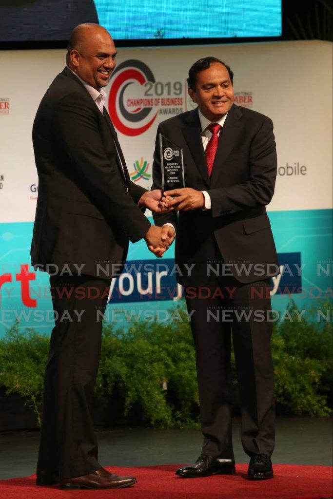 In this 2019 file photo, Guardian Life president Anand Pascal presents the Business Hall of Fame award to Coosal’s Group of Companies chairman Sieunarine Coosal at the TT Chamber's Champions of Business Awards ceremony at NAPA, Port of Spain. - FILE PHOTO