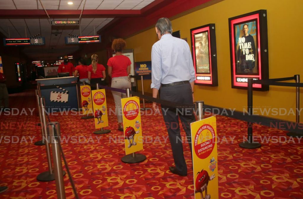 Patrons practise physical distancing at MovieTowne, Mucurapo on June 26 during reopening after the first lockdown in March. Cinemas have to once again close due to significant increases in covid19 cases. - SUREASH CHOLAI